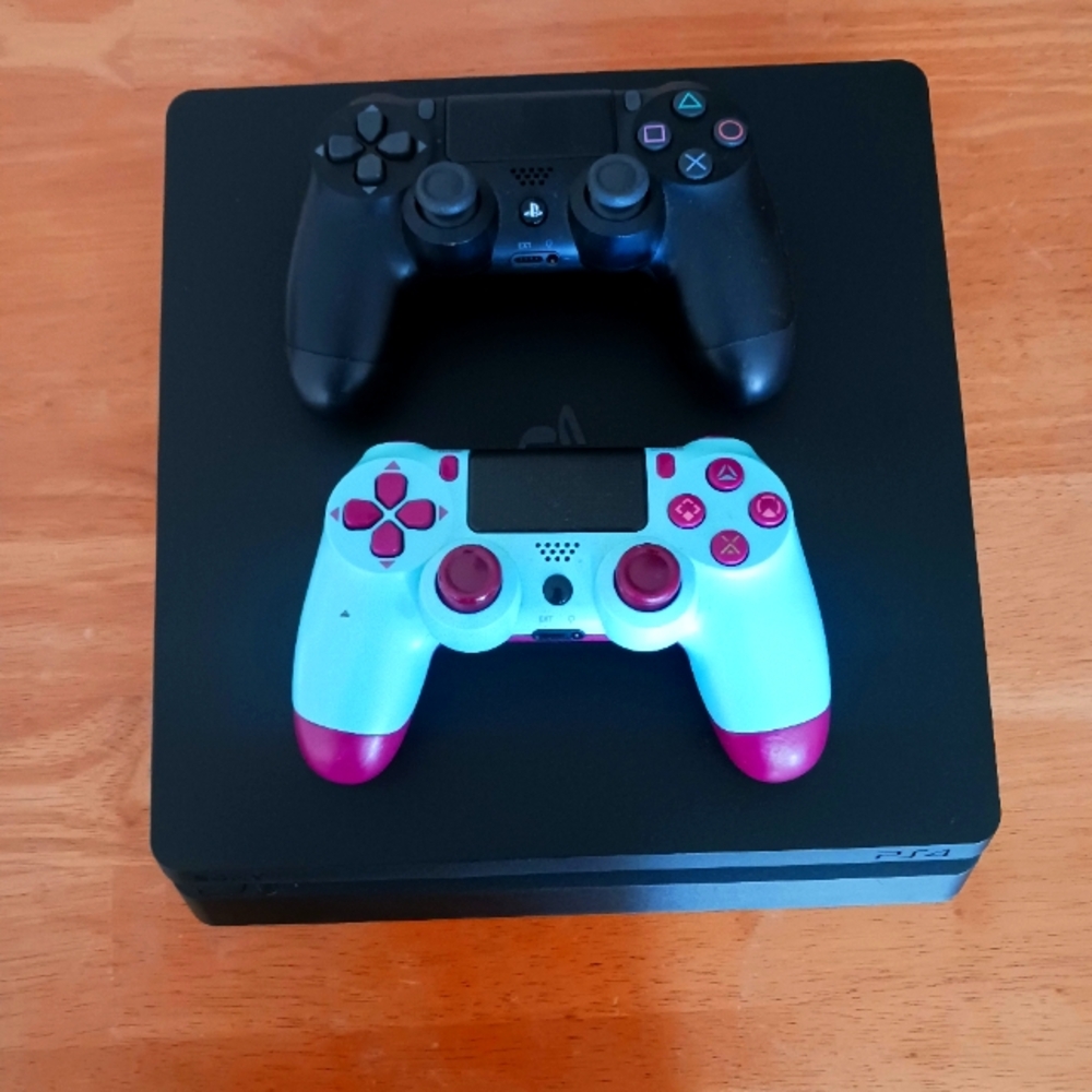 Sony PlayStation 4 Console with Black and Light Blue Controllers